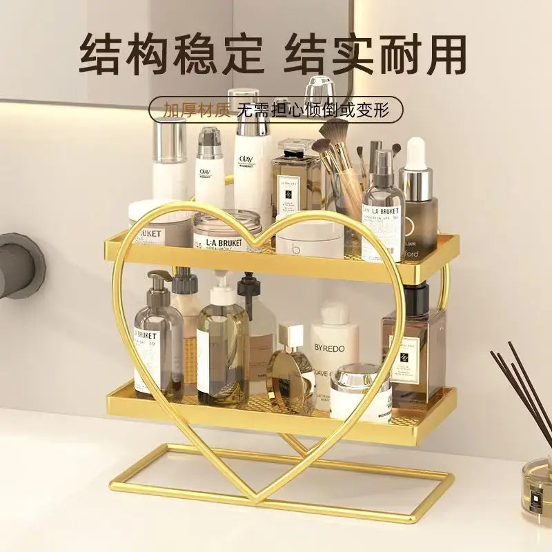 White and golden heart-shaped two-tier metal shelf holding beauty products decorbites golden makeup organizer