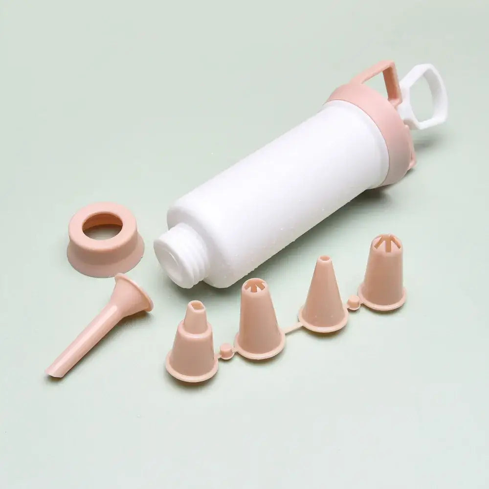 White and gray cream decorating gun with pink and white plastic syringe and assorted piping tips for cake cream decorating