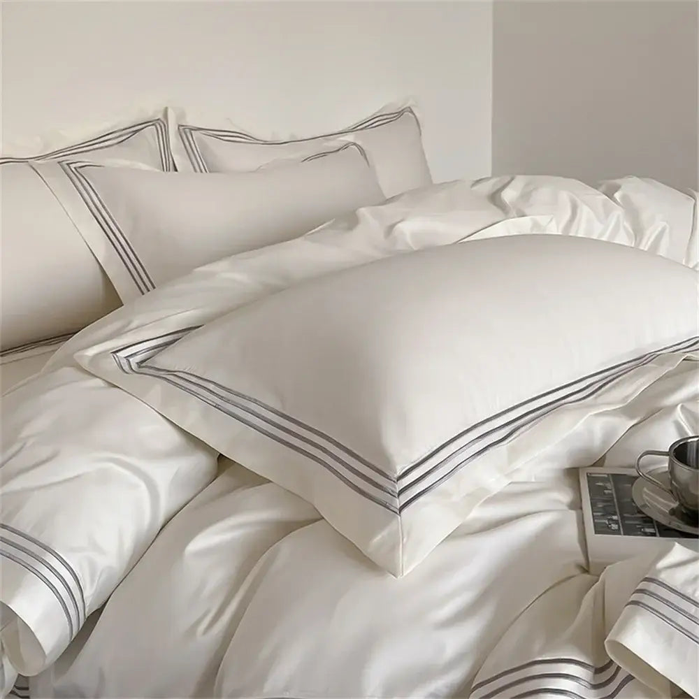 White and gray egyptian cotton bedding set featuring white satin pillowcases with elegant black double-stitched trim decorbites 1200tc embroidered