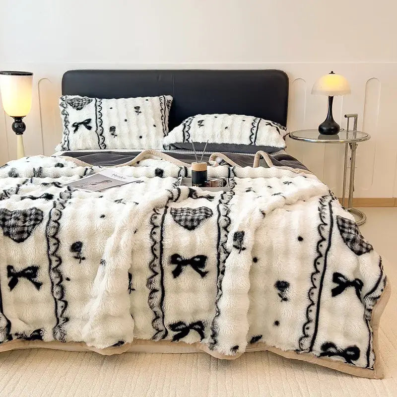 White and green cartoon printed faux rabbit plush blanket with white plush fabric black embroidered bows and lace trim