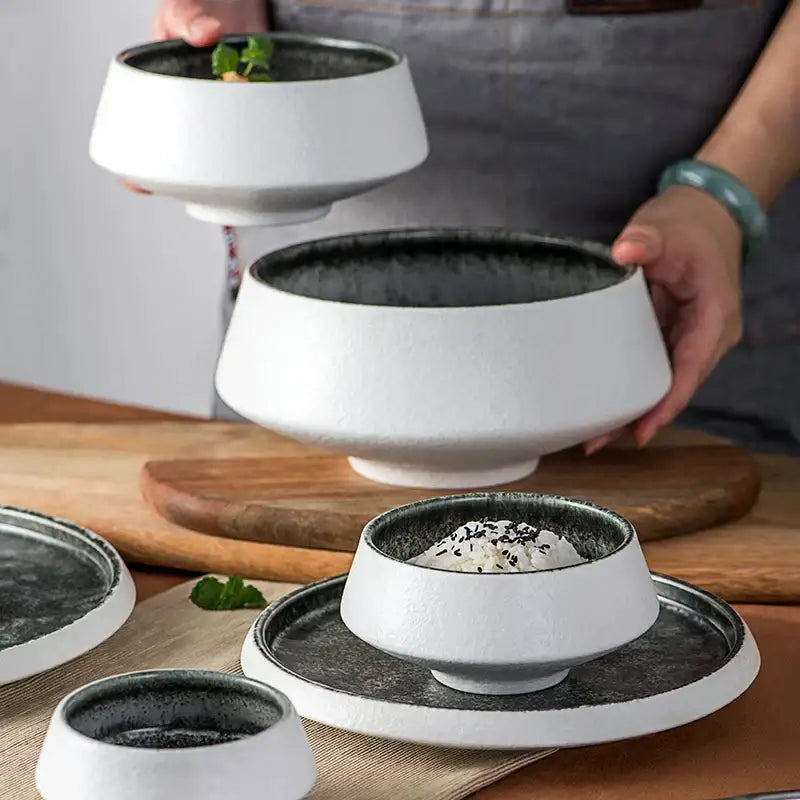 White ceramic bowls with textured exteriors and dark grey speckled ice cracked glaze interiors from decorbites dinnerware set
