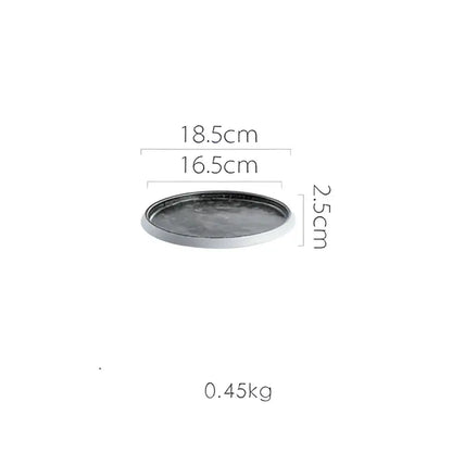 Dark gray round ceramic tray with matte finish and slightly raised rim from decorbites ice cracked glaze dinnerware set