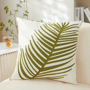 White pillow cover with olive green embroidered leaf design for living room decor featuring embroidered leaf pillow style