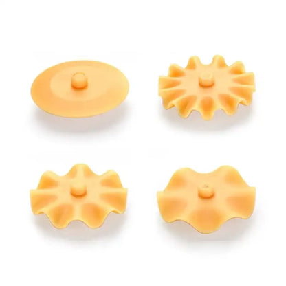 Set of four orange silicone sink strainers with petal designs paired with white and orange decorbites dough roller cutter