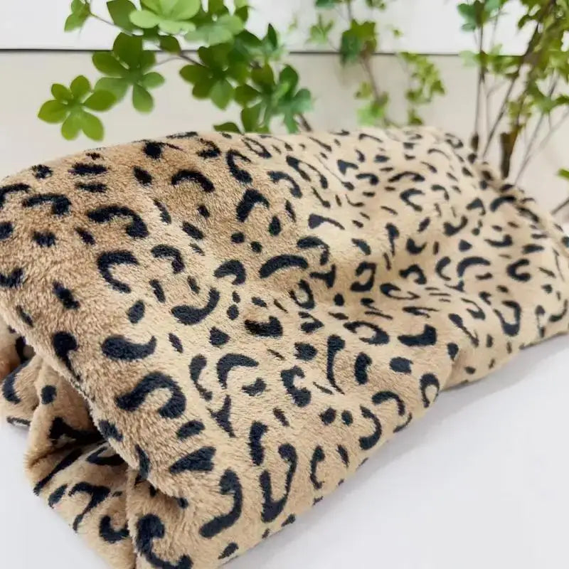 A plush tan and black leopard print warm fleece throw blanket ideal for cozy decorbites leopard print decor