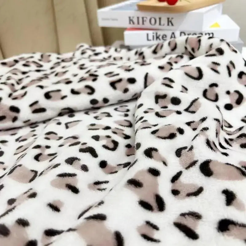 A plush white and orange leopard print warm fleece blanket by decorbites with soft fuzzy texture for bedroom decor