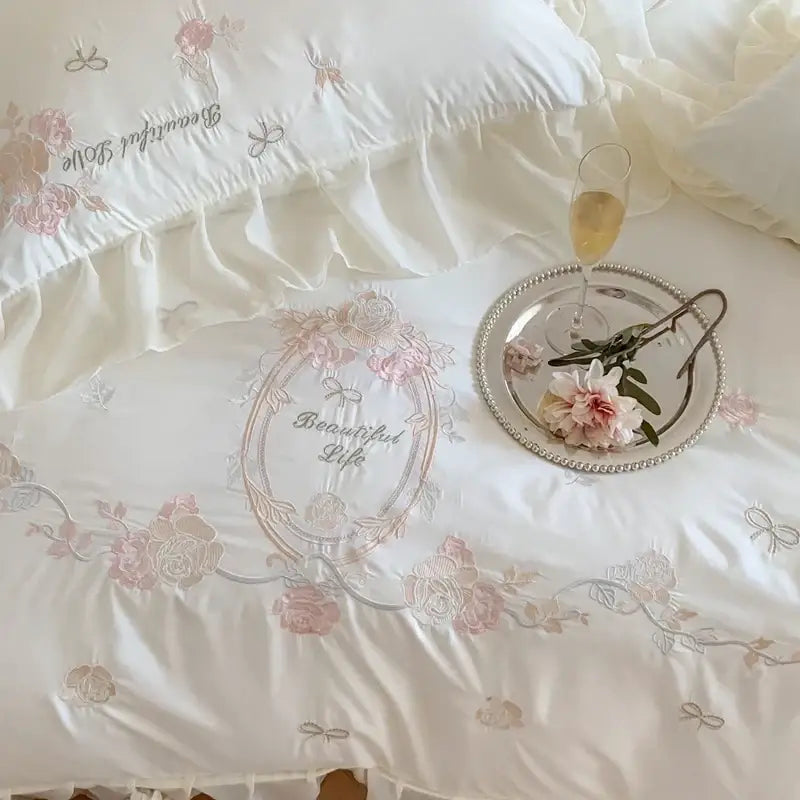 White satin duvet cover with delicate pink and silver flowers embroidery in a 4pcs flowers embroidery bedding set