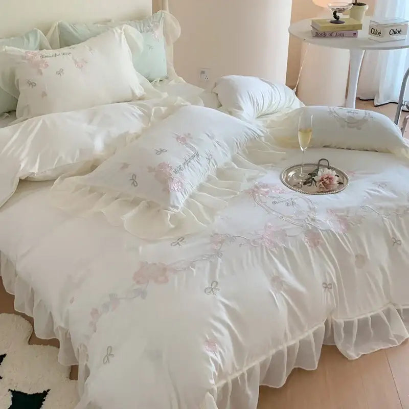 White and pink 4pcs flowers embroidery bedding set with delicate floral ruffles in a bedroom bedding set