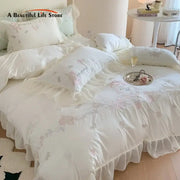 White and pink 4pcs flowers embroidery bedding set with ruffles featuring delicate pink floral embroidery and gray bows