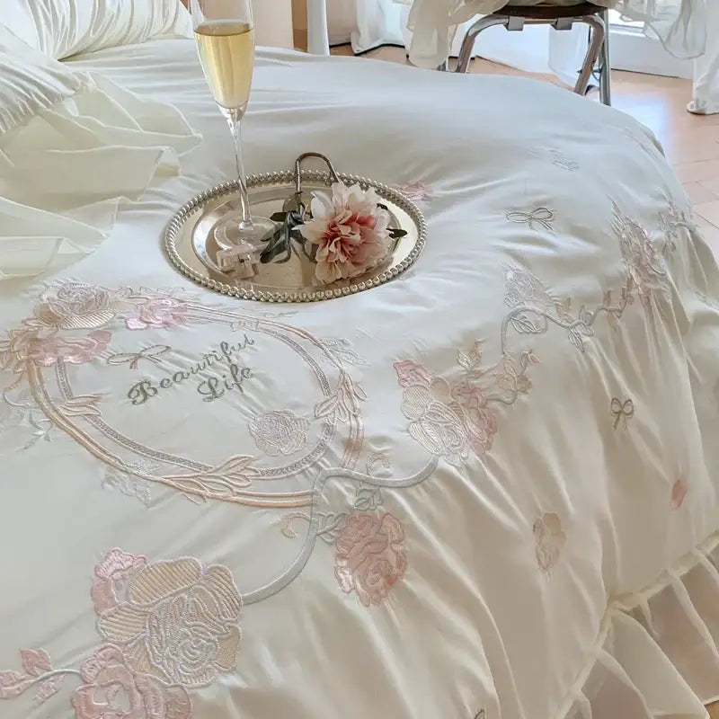 Cream-colored satin bedding set with delicate white and pink 4pcs flowers embroidery and beautiful life stitched design