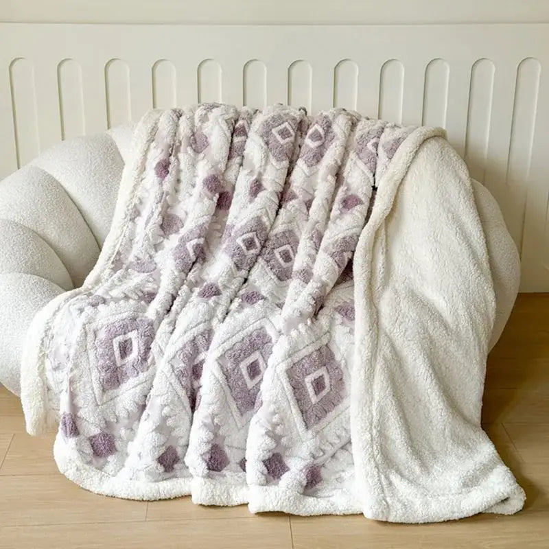 A plush white and lavender geometric jacquard taff velvet bedroom throw blanket with a soft textured surface