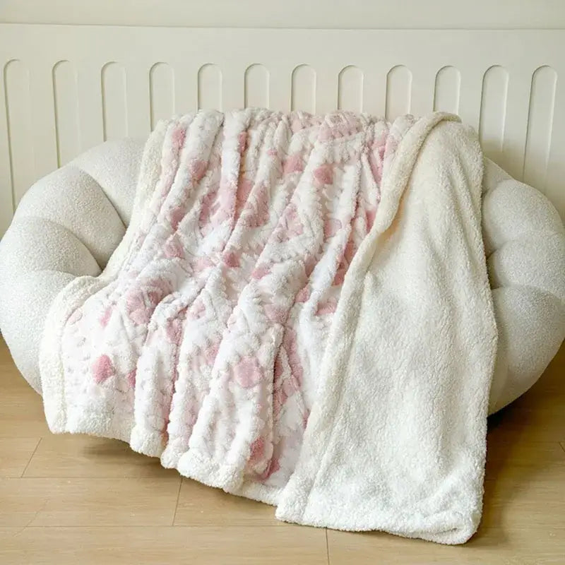 A plush white and pink floral-patterned geometric jacquard taff velvet blanket with soft fuzzy texture for bedroom decorbites