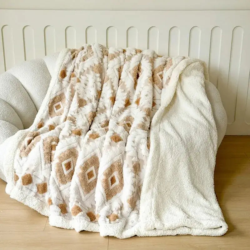 A plush white and beige geometric jacquard taff velvet throw blanket with soft textured surface for bedroom decorbites decor