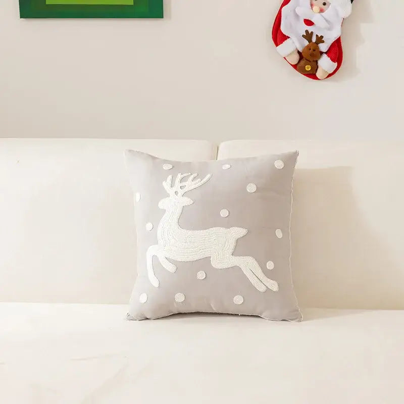 Gray square pillow with white embroidered reindeer and polka dots in decorbites embroidered christmas pillow cases