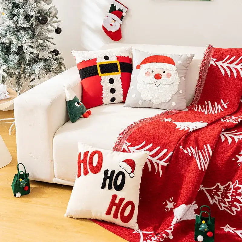 White and red embroidered christmas pillow cases with plush textured throw blanket featuring pine tree decorbites embroidered christmas patterns