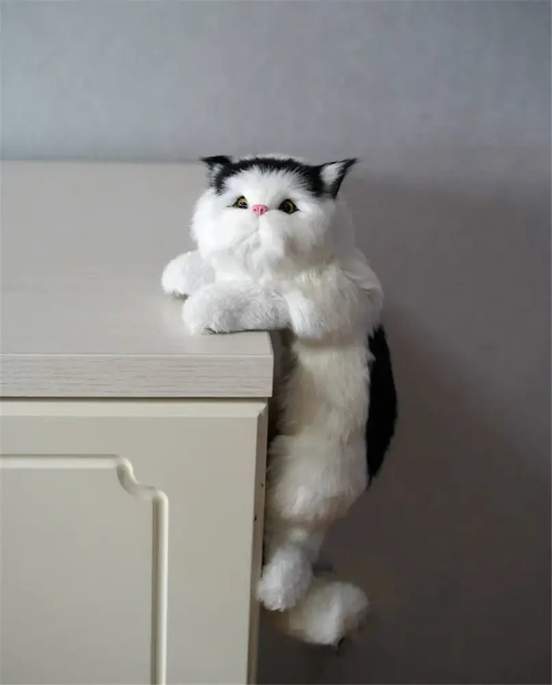 A plush black and white cat plush doll with green eyes and pink nose for decorbites hanging cat living room decor