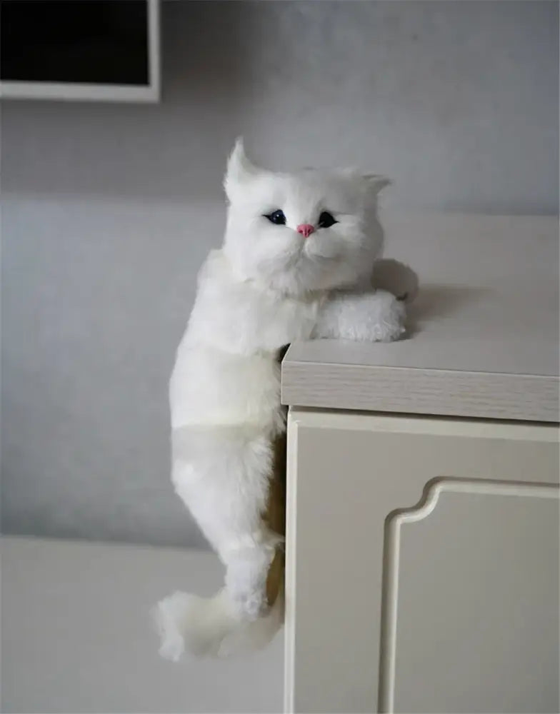 A white and tan hanging cat plush doll made of soft synthetic fur featuring black eyes and a pink nose for decorbites hanging cat decor