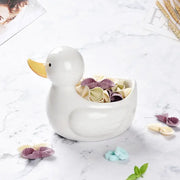 White and yellow decorbites duck ceramic dessert bowl filled with colorful bow-tie pasta for dining room serving
