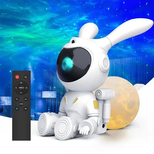 White and yellow galaxy bunny astronaut night light with glowing teal lens beside a moon lamp for bedroom decorbites decor