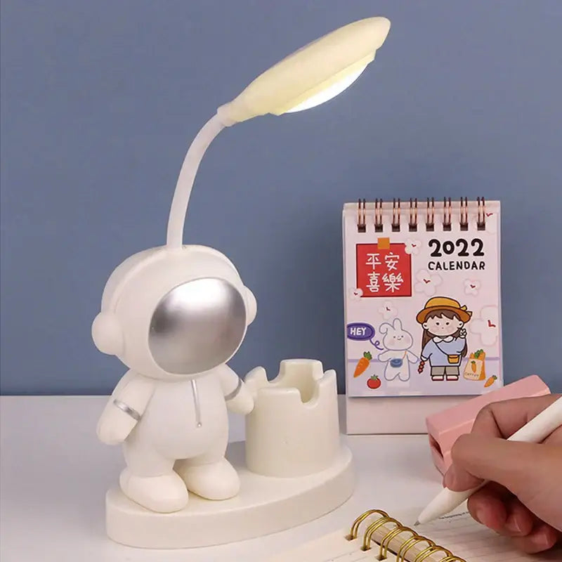 White astronaut desk lamp with pencil sharpener featuring silver visor and flexible neck for decorbites astronaut study