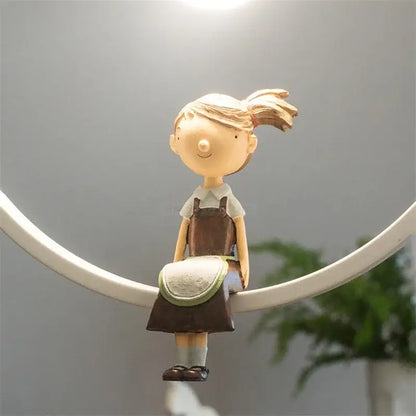 A beige resin figurine of a girl with blonde hair in ponytail paired with white bird iron ring pendant light decorbites iron ring pendant