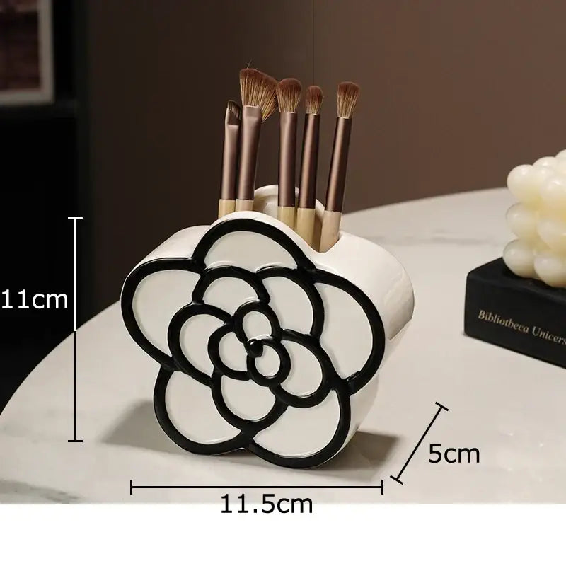 White ceramic flower-shaped brush holder with black outline design for decorbites butterfly ceramic tissue box decor