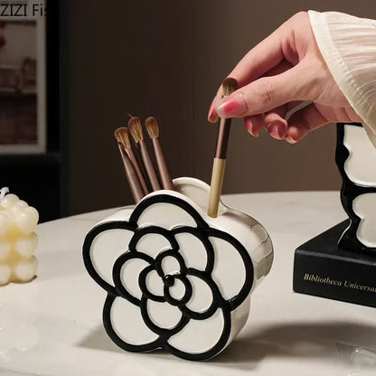 White ceramic flower-shaped brush holder with black outline detailing for decorbites butterfly ceramic tissue box decor
