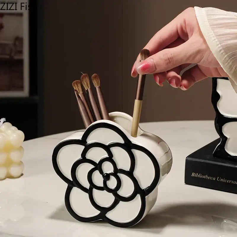 White ceramic flower-shaped brush holder with black outline detailing for decorbites butterfly ceramic tissue box decor