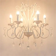 White wrought iron chandelier with crystal pendants and candle-style bulbs for decorbites black white metal decor