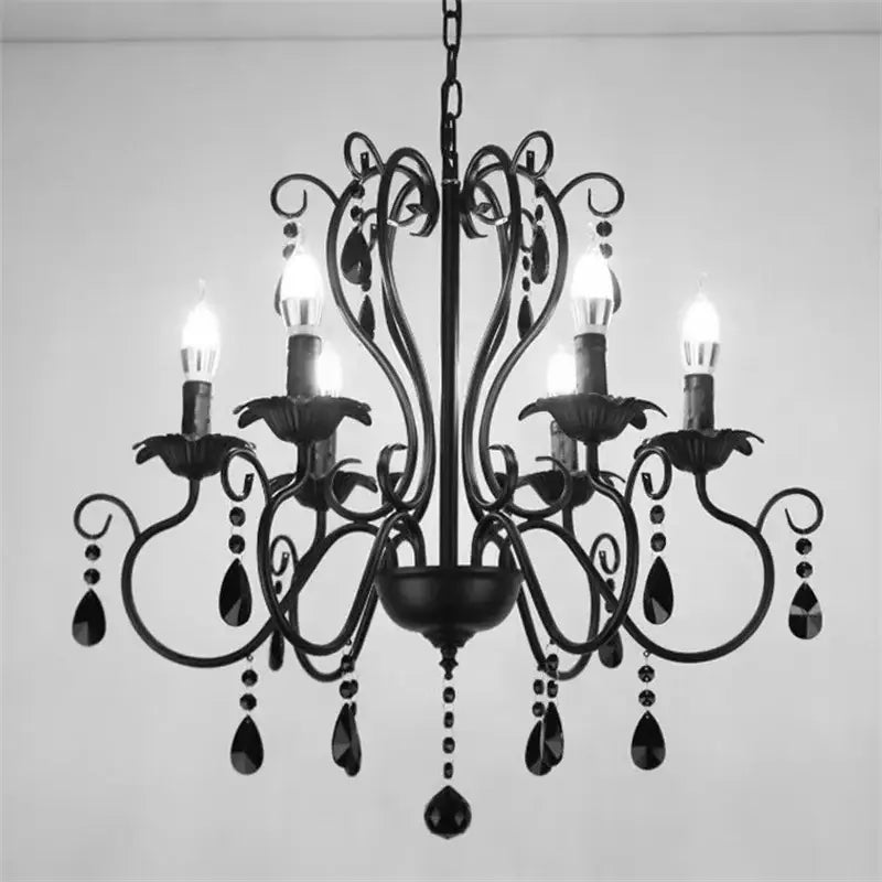 Black white metal chandelier with crystal pendants featuring ornate scrollwork and candle-style bulbs for dining room decorbites black white