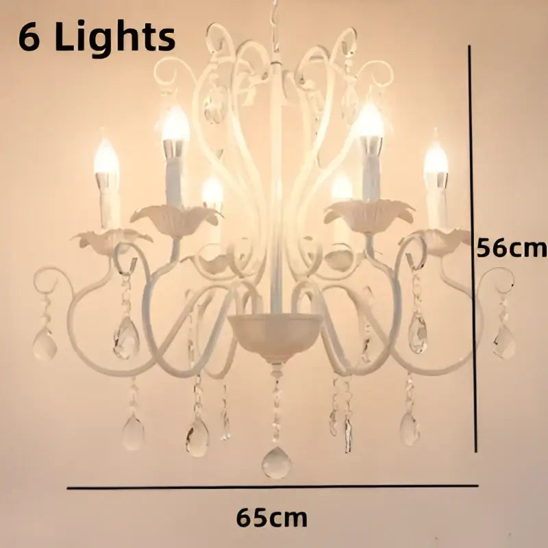 White and black metal chandelier with crystal pendants featuring six lit candle bulbs for dining room decorbites black white