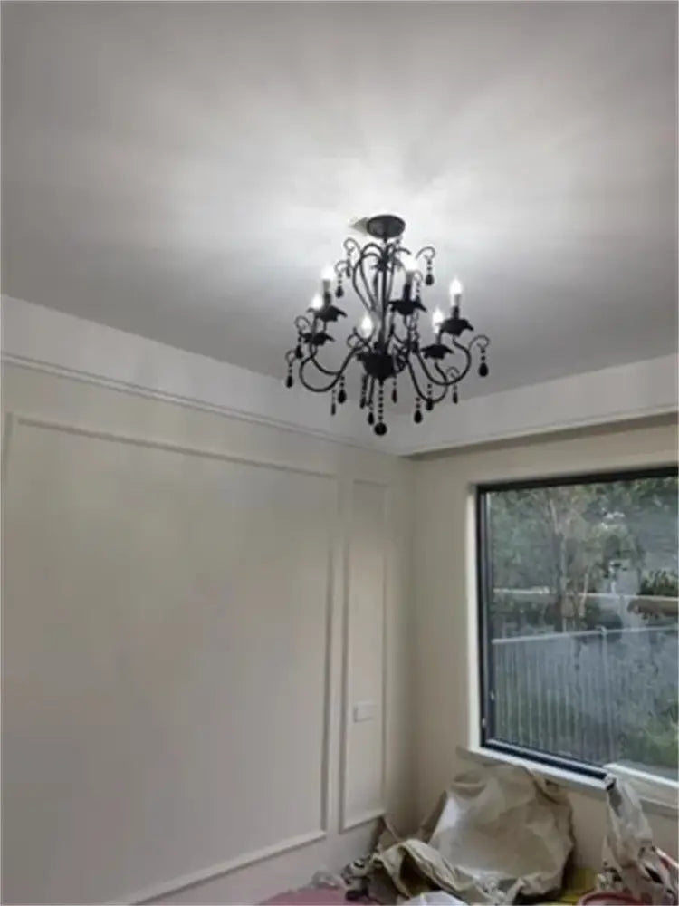 Black white metal chandelier with crystal pendants featuring multiple lit bulbs for dining room decorbites black white