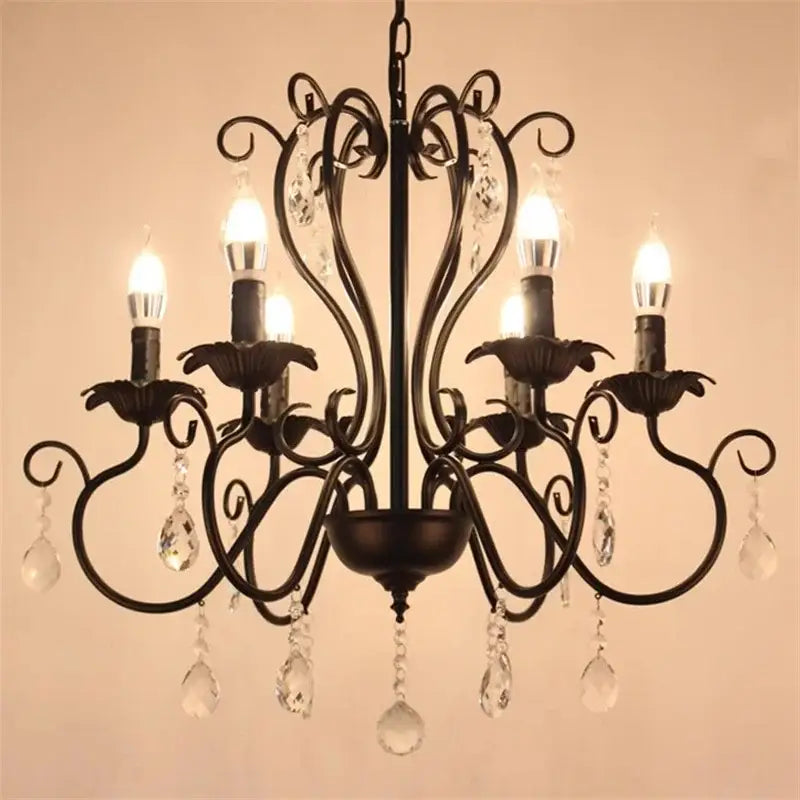 White and black metal chandelier with crystal pendants featuring black wrought iron and candle-style bulbs for dining room decorbites black white