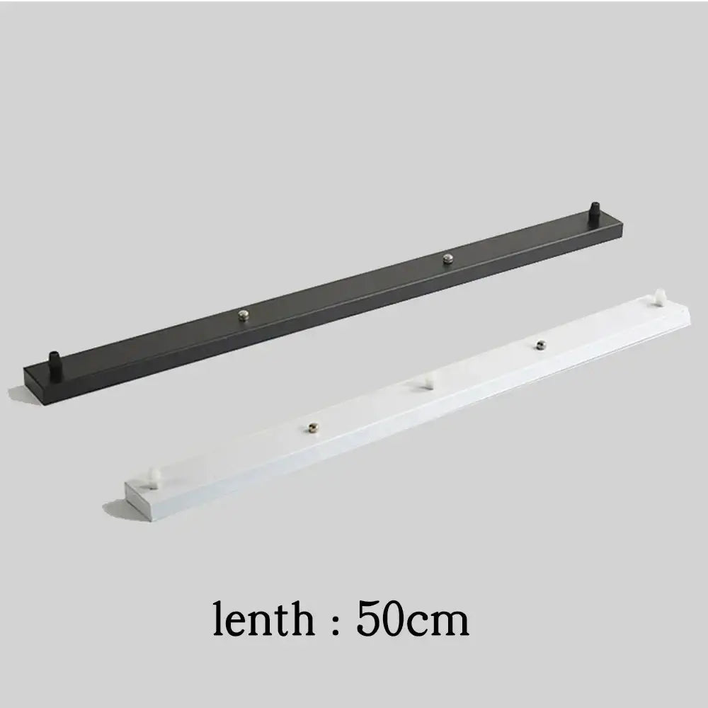 Black and white wall-mounted coat racks with evenly spaced hooks complement decorbites ceiling mount pendant light canopy