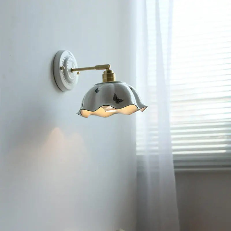 White butterfly ceramic led wall lamp with fluted petal shade and brass hardware for bedroom scalloped sconce design