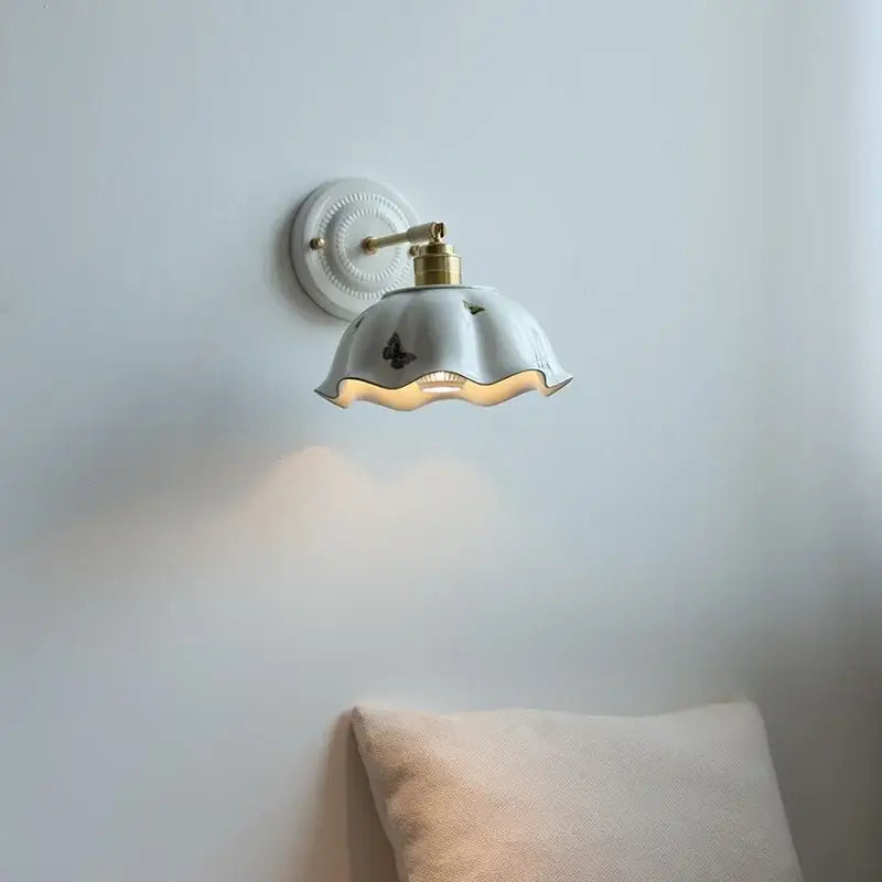 White butterfly ceramic led wall lamp with scalloped shade and brass accents for bedroom wall sconce lighting