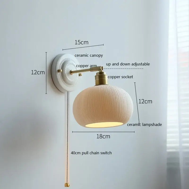 Cream-colored butterfly ceramic led wall lamp with ribbed scalloped lampshade and brass accents for bedroom use
