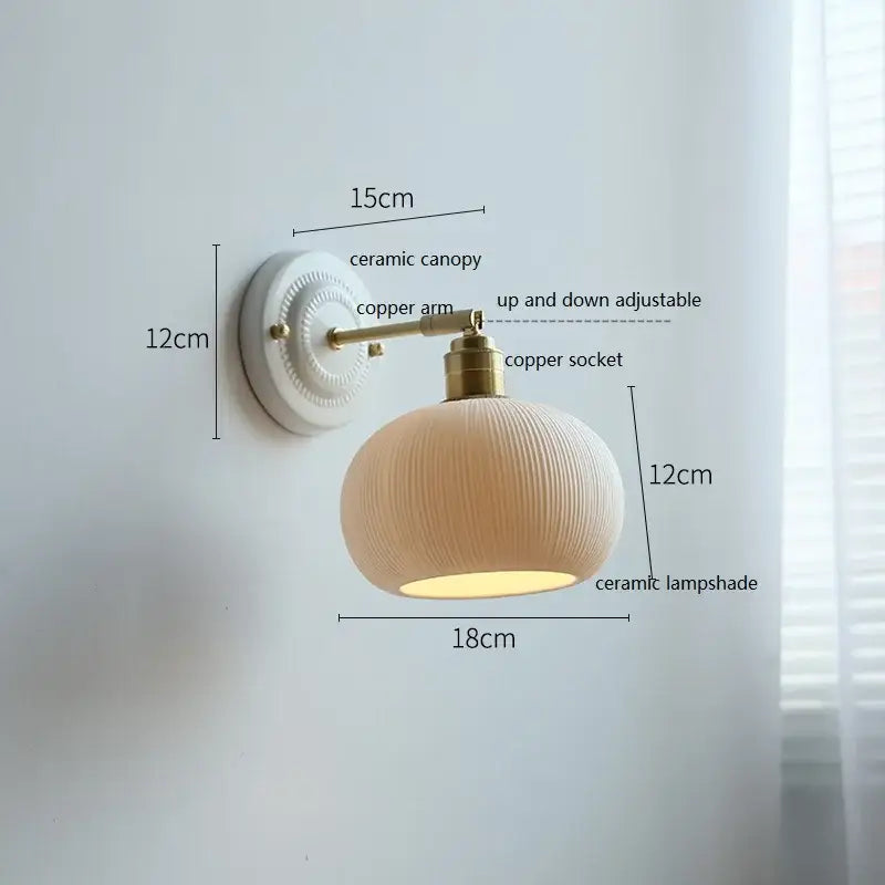 Cream-colored butterfly ceramic led wall lamp with ribbed scalloped shade and brass-finished copper arm for bedroom use