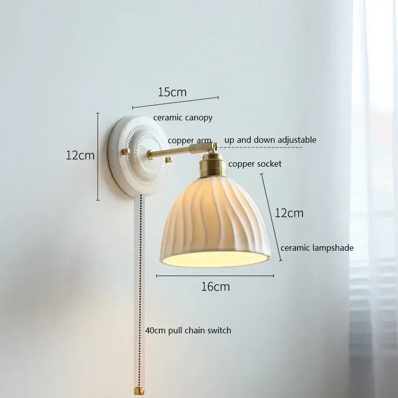 Cream-colored butterfly ceramic led wall lamp with fluted scalloped shade and brass-finished copper arm for bedroom