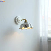 White butterfly ceramic led wall lamp with gold metal arm and scalloped black butterfly ceramic led sconce shade