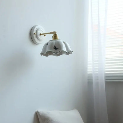White butterfly ceramic led wall lamp with gold-toned arm and ruffled shade featuring subtle butterfly ceramic led decals