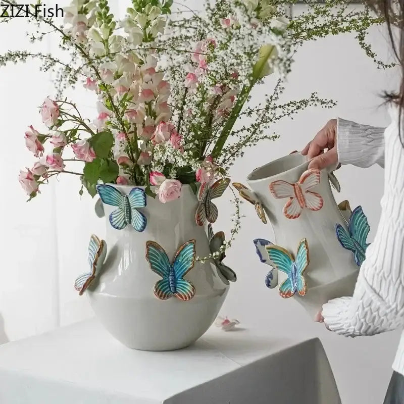 White butterfly ceramic vase by decorbites with colorful three-dimensional blue teal and orange butterfly decor for living room