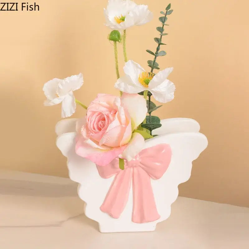 White butterfly ceramic vase with pink bow holding artificial white and peach flowers for living room decorbites butterfly ceramic