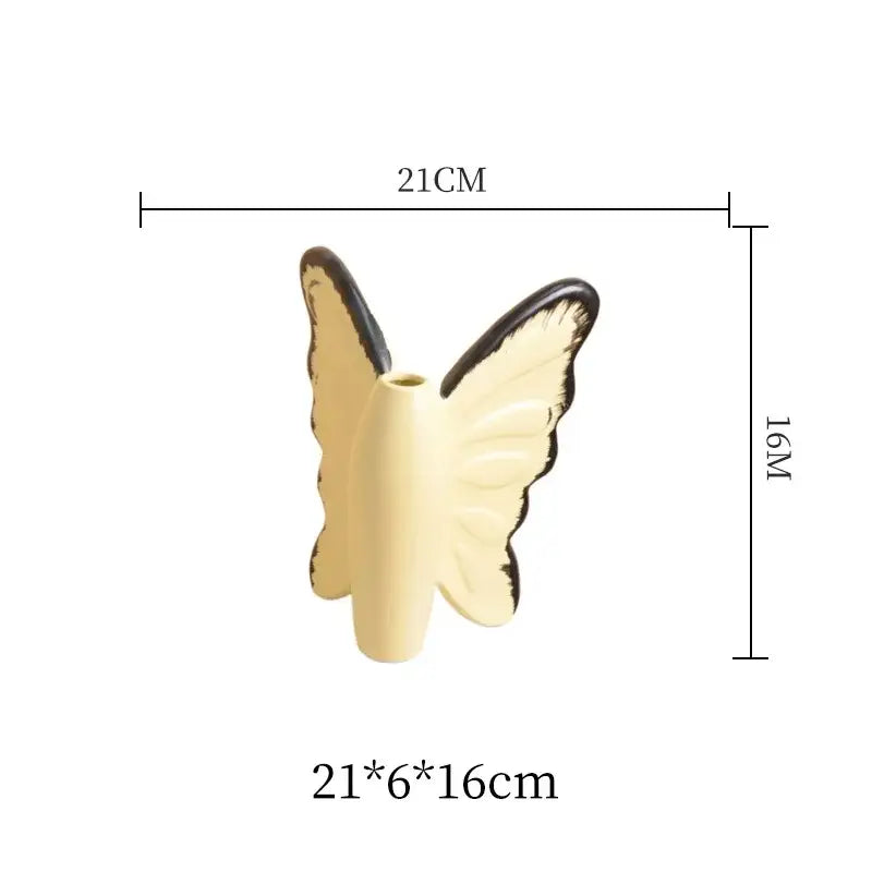 Cream-colored decorbites butterfly ceramic vase with black-edged wings and pink bow for elegant living room decor