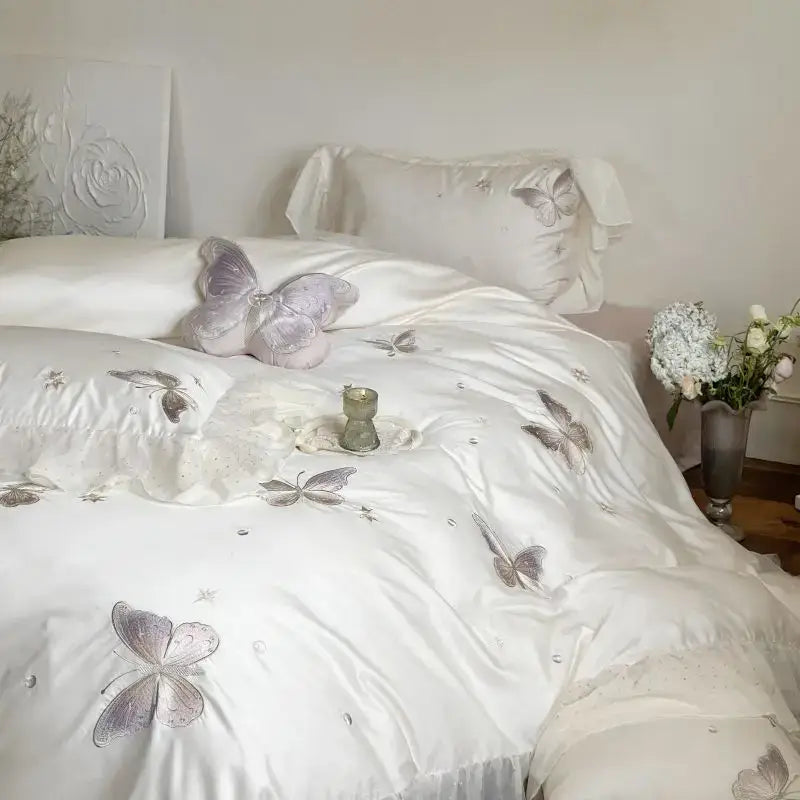 White satin bedding set with silver butterfly lace ruffles embroidery and subtle shimmering accents by decorbites butterfly lace