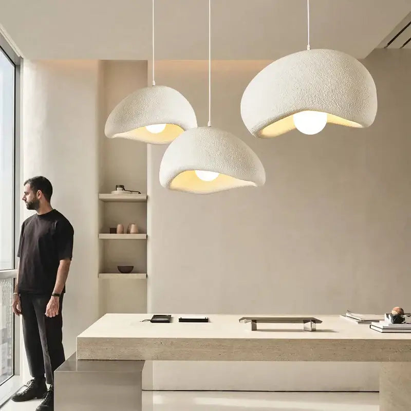 Three white textured dome-shaped pendant lights made of decorbites cement wind cloud for living room decor
