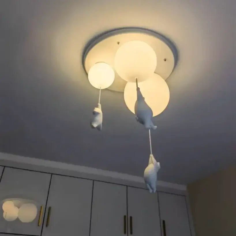 White ceramic bear pendant light with three spherical bulbs and dangling figurines for bedroom ceiling use