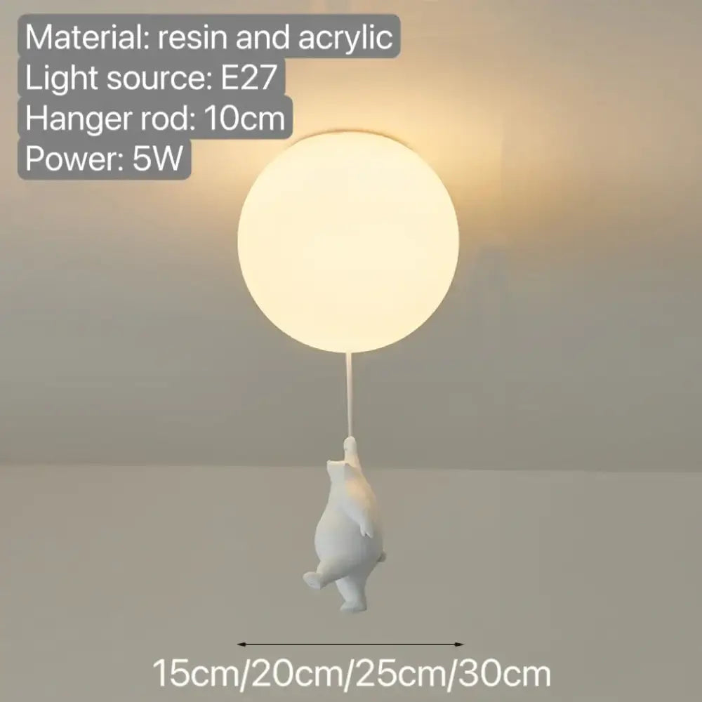 White resin and acrylic bear pendant light with a softly glowing orb ceiling lamp for bedroom lighting