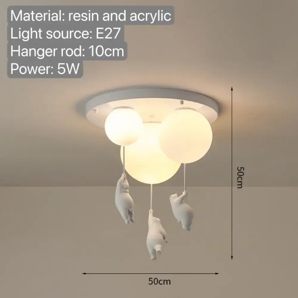 White ceramic pendant light with three spherical acrylic bulbs and dangling bear figurines for bedroom use