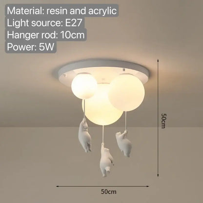 White ceramic pendant light with three spherical acrylic bulbs and dangling bear figurines for bedroom use